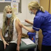 Clinical site manager Claire Bonner aged 49 receives her vaccine from staff nurse Jennifer Love-Hughes.