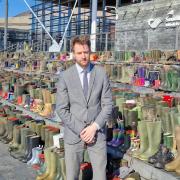 Sam Rowlands MS for North Wales with the display of the empty wellies on the steps of the Senedd.
