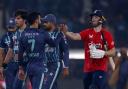 England's Phil Salt, right, shakes hand with Pakistan's Shadab Khan, third left, on the end of the sixth twenty20 cricket match between Pakistan and England, in Lahore, Pakistan, Friday, Sept. 30, 2022. (AP Photo/K.M. Chaudary).