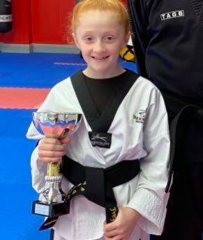 Freya Roberts with the trophy she won for being best student in Wales of any age grading for her black belt.
