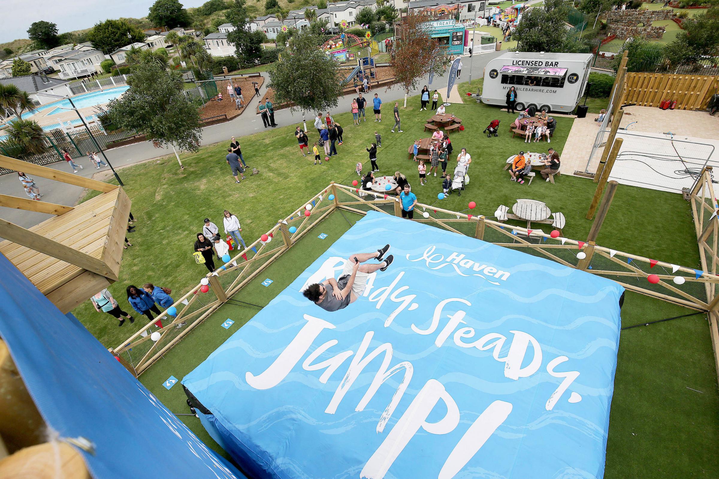 EDITORIAL USE ONLY Holidaymakers try out Havens The Jump, which was opened today by Denise Lewis OBE, during a visit to Presthaven in Prestatyn, Wales. Picture date: Thursday July 15, 2021. PA Photo. The new addition is part of the Park of the Future