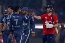 England's Phil Salt, right, shakes hand with Pakistan's Shadab Khan, third left, on the end of the sixth twenty20 cricket match between Pakistan and England, in Lahore, Pakistan, Friday, Sept. 30, 2022. (AP Photo/K.M. Chaudary).