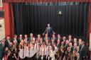 Those who took part in the concert, with compere Glyn Owens at the back.