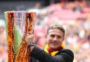 Bradford City manager Phil Parkinson celebrates with the npower Football League Two Play Off final trophy, following their victory over Northampton Town.