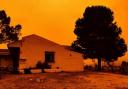 An orange sky is seen over a building in Navares, south eastern Spain (Europa Press via AP, photo via PA)