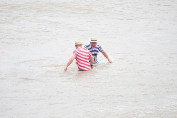 Rob Lloyd (left) and Adam Williams take a dip in the sea of North Shore, Llandudno on Saturday.