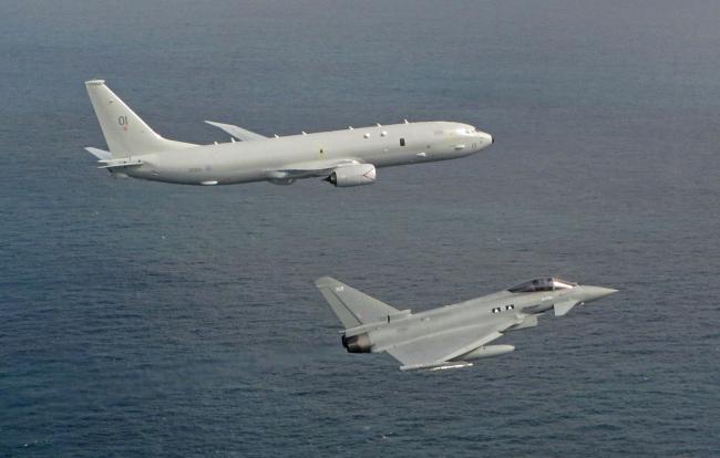 Undated handout photo issued by the Royal Air Force of a P-8A Poseidon and Typhoon overflies Vasily Bykov over the North Sea.