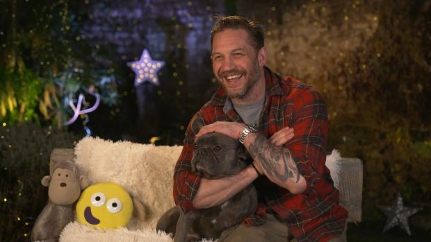 Denbighshire Free Press: Tom Hardy on CBeebies Bedtime Stories accompanied by his French Bulldog Blue. Picture: PA