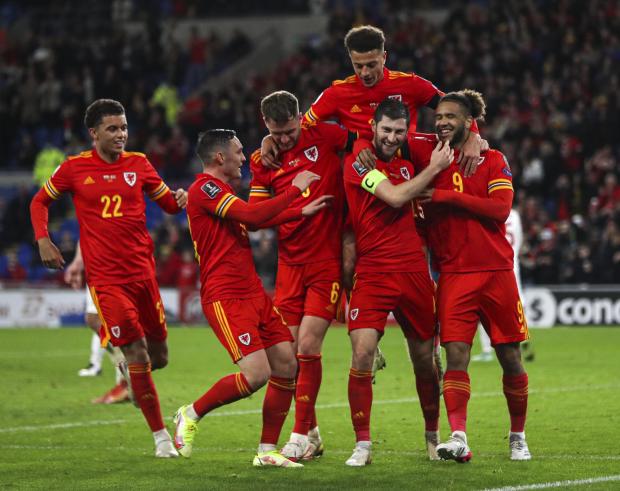 Denbighshire Free Press: Wales' Ben Davies (second right) celebrates scoring their side's fourth goal of the game during the FIFA World Cup Qualifying match at the Cardiff City Stadium, Cardiff. Picture date: Saturday November 13, 2021.