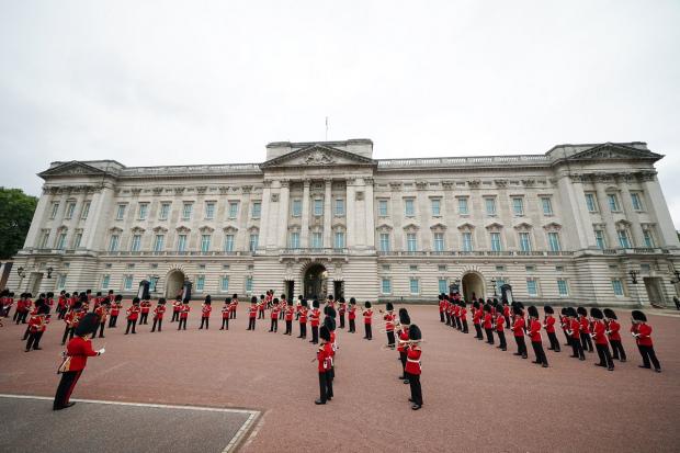 Denbighshire Free Press: Members of the Nijmegen Company Grenadier Guards and the 1st Battalion the Coldstream Guards take part in the Changing of the Guard, in the forecourt of Buckingham Palace. Picture: PA
