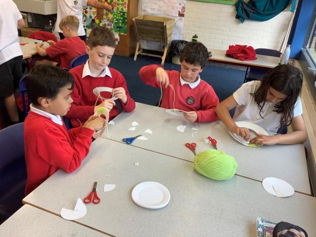 Denbighshire Free Press: Year five pupils making pom-poms