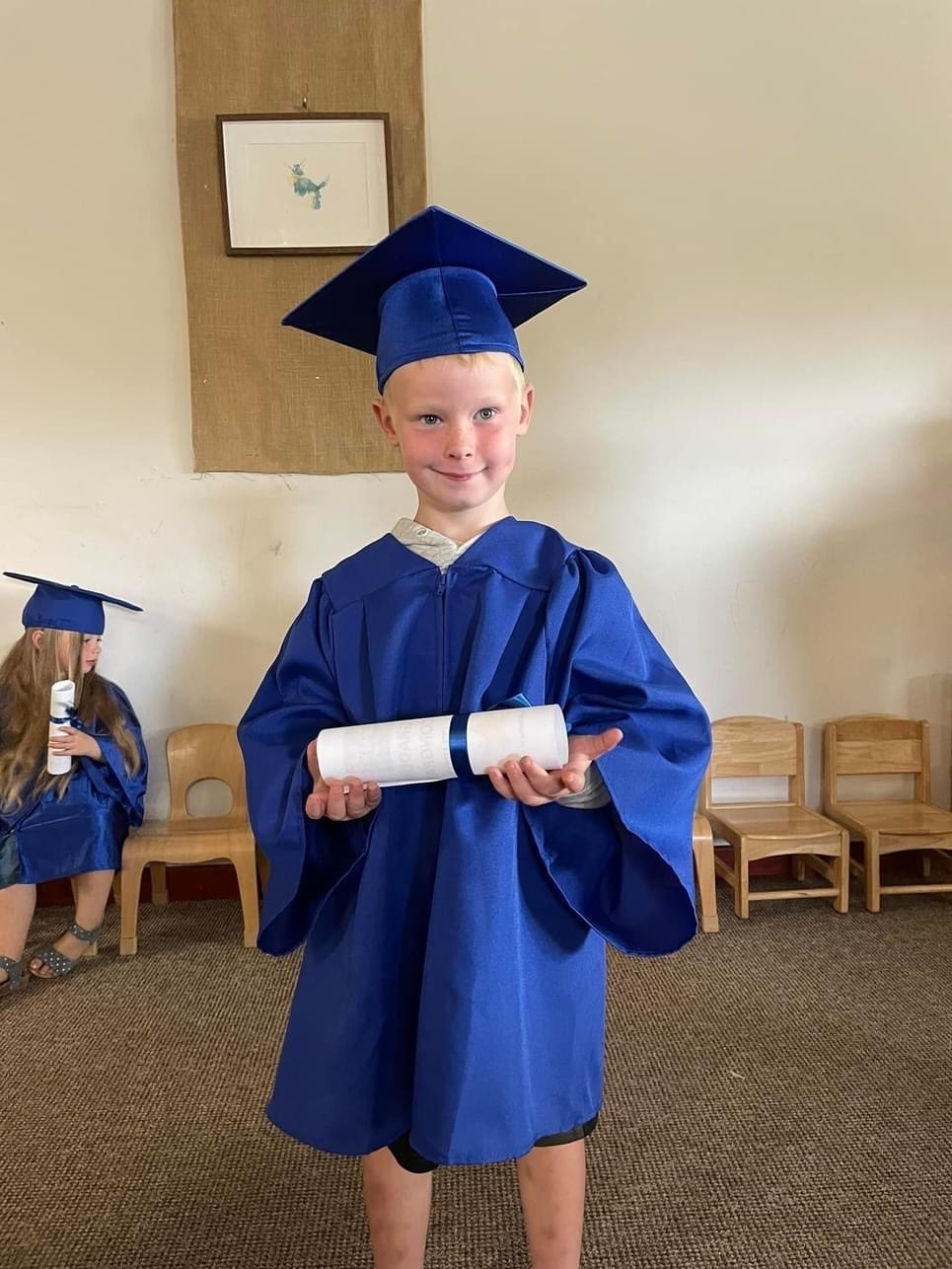 Theo looking smart in his cap and gown at Corwen Day Nursery.