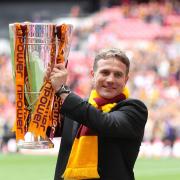 Bradford City manager Phil Parkinson celebrates with the npower Football League Two Play Off final trophy, following their victory over Northampton Town.
