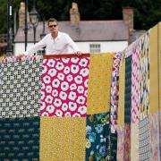 Artist Luke Jerram at the unveiling of his new artwork 'Bridges, Not Walls', a giant patchwork covering the Llangollen Bridge in north Wales, for the launch the Llangollen Eisteddfod.
