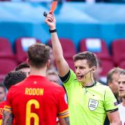 Wales defender Joe Rodon looks on as a red card is shown to a teammate against Denmark in the Euros but the country says  Wales is the only UK country that meets its quarantine free travel requirements. Picture: PA Wire/PA Images