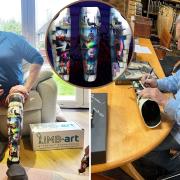 Mike Elkins with his Pink Floyd-inspired prosthetic cover, which is being signed by Nick Mason (right)