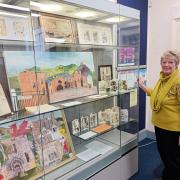 Artist Linda Kinsey with her exhibition at Ruthin Library