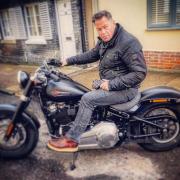 Trainee priest, Stuart Dean on his motorcycle.