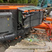 The overturned digger in Lesley Knight's garden in Llangollen.
