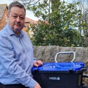 Denbighshire leader Cllr Jason McLellan with one of the council's new recycling ‘Trolibocs on wheels’ - to replace the blue bin.