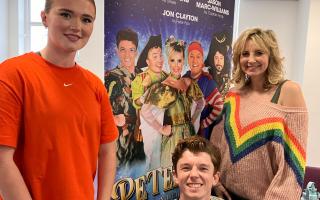 Georgia Conwy, Jon Clayton and Carley Stenson by the poster for Peter Pan.